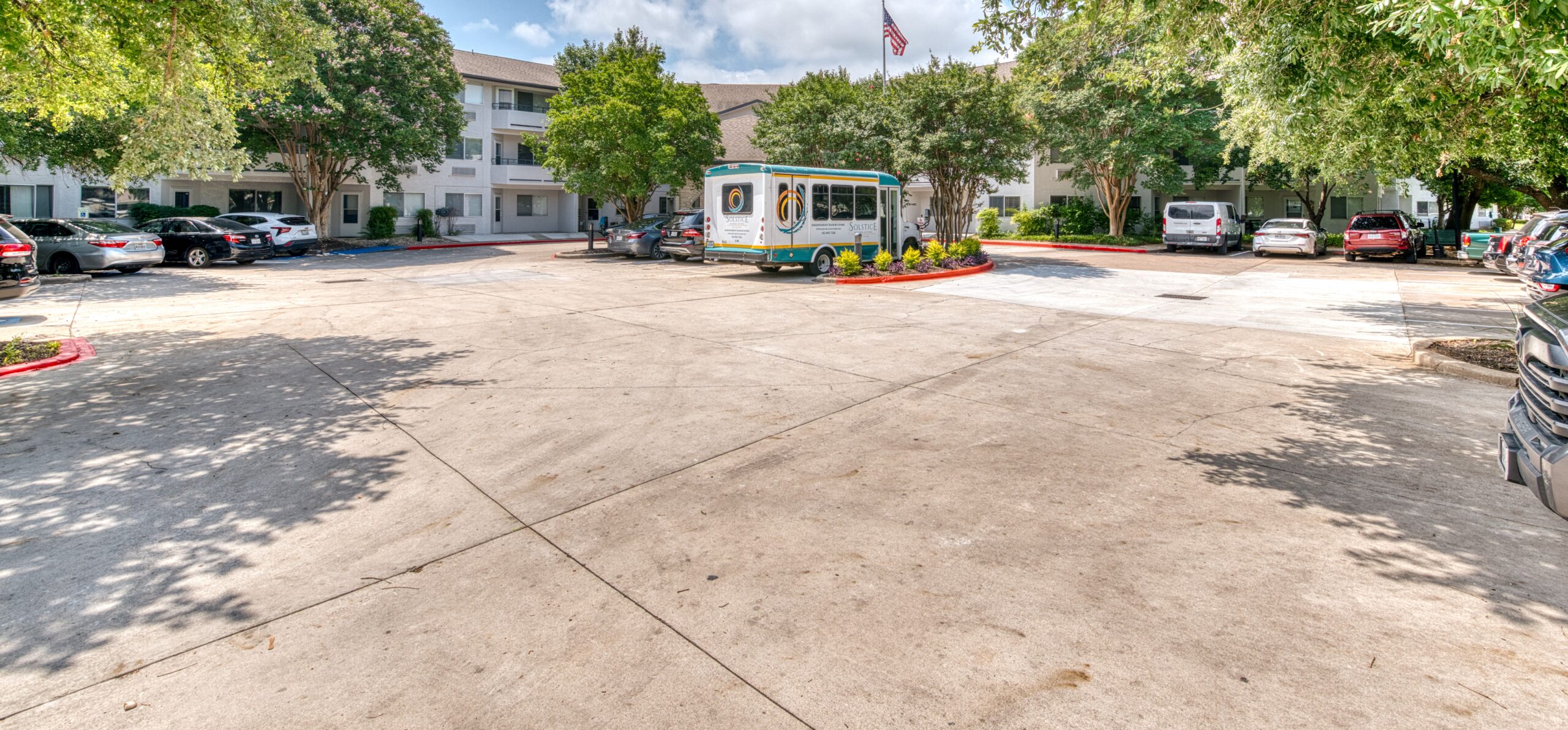 Exterior view of Solstice Senior Living with transportation van