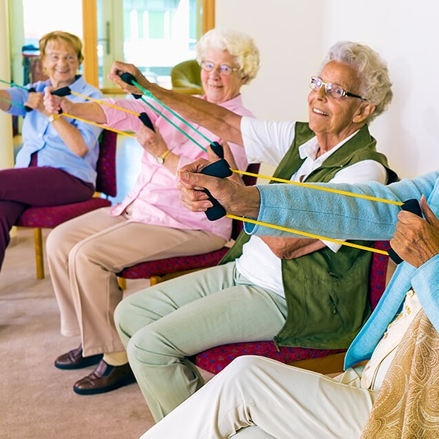 Residents participating in a group exercise session indoors