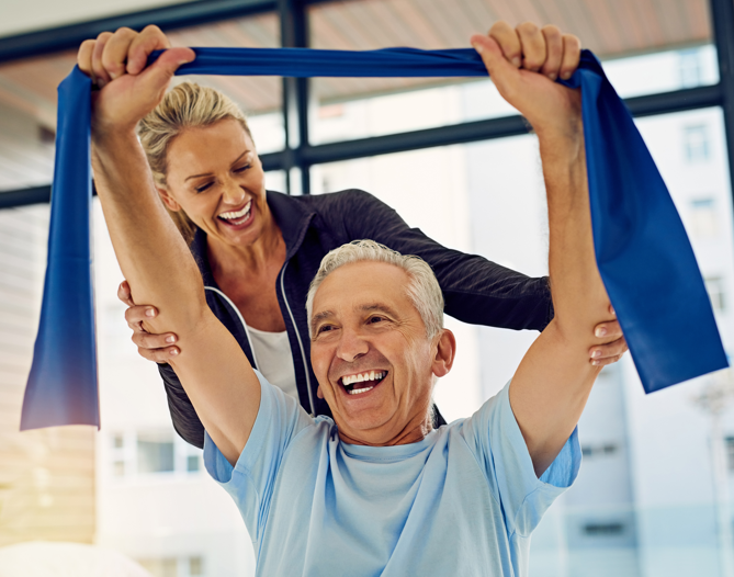 Senior man exercising with staff assistance