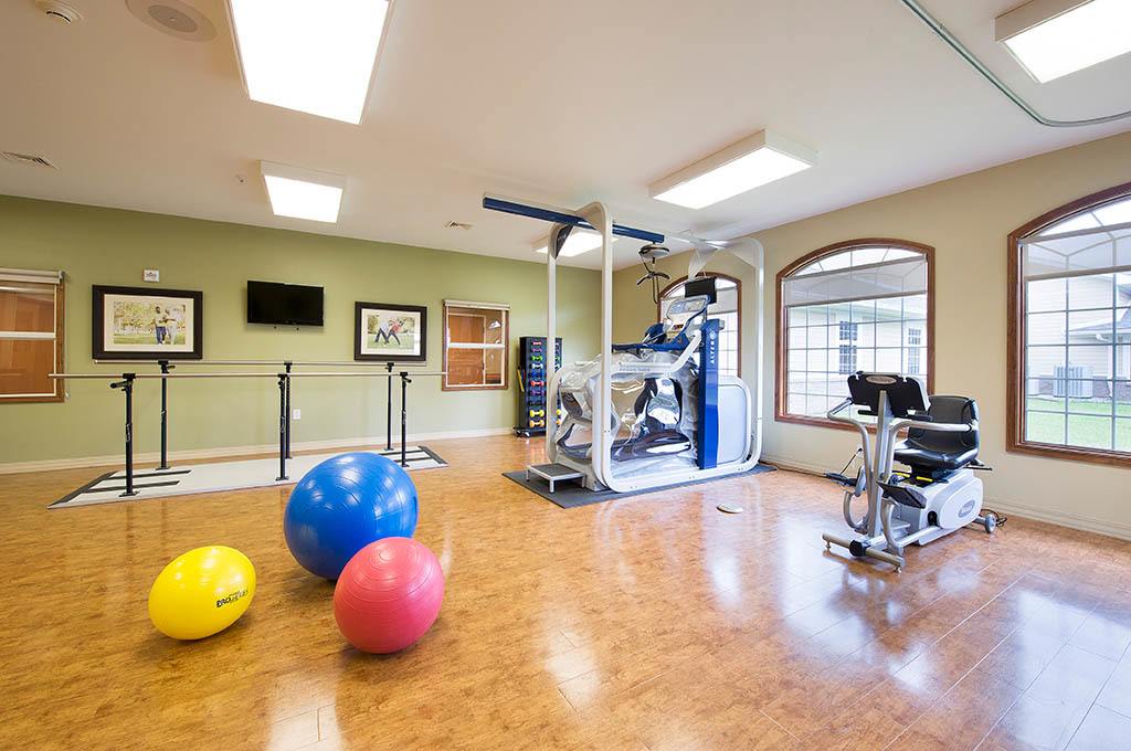 Interior therapy room with exercise equipment and colorful balls