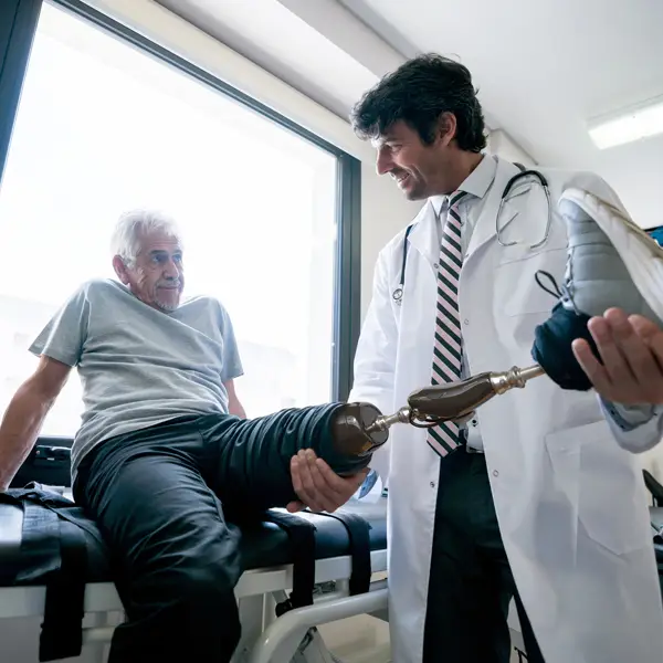A doctor assisting a patient with a prosthetic leg
