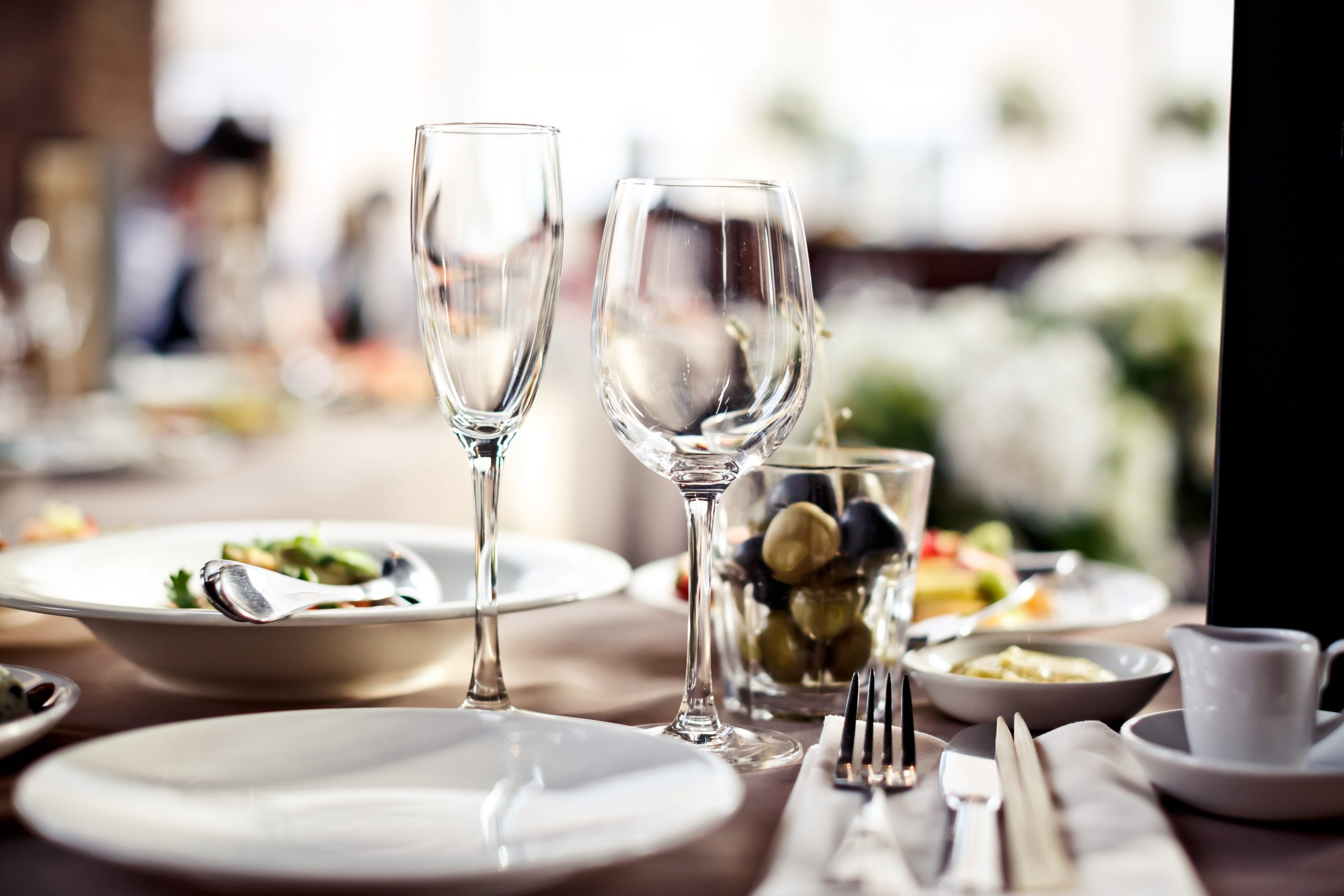 Elegant dining table set with glasses and meals