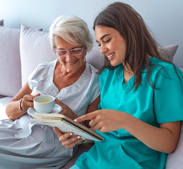 A caregiver and resident sharing a joyful moment indoors
