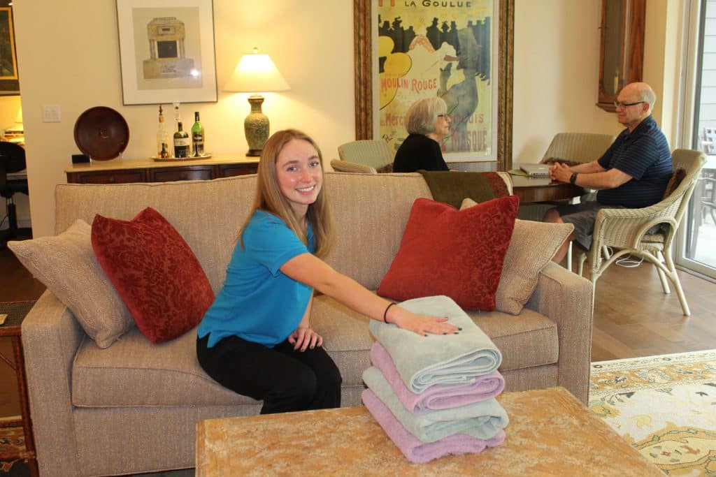 Staff member arranging towels in a common area