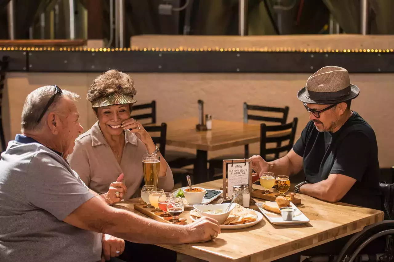 Residents enjoying dinner and drinks at a table