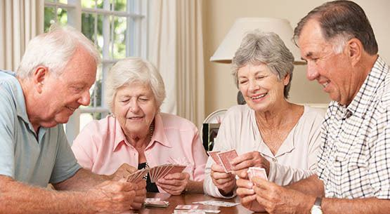 Residents playing cards in an activity room