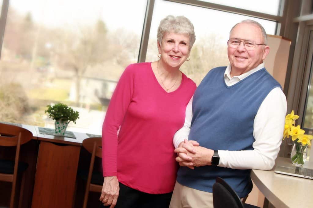 Two smiling residents in a bright common area