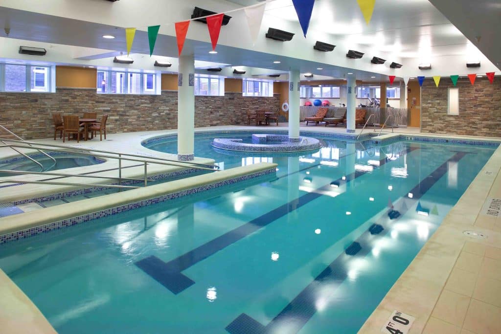 Indoor pool area with seating and decorative flags