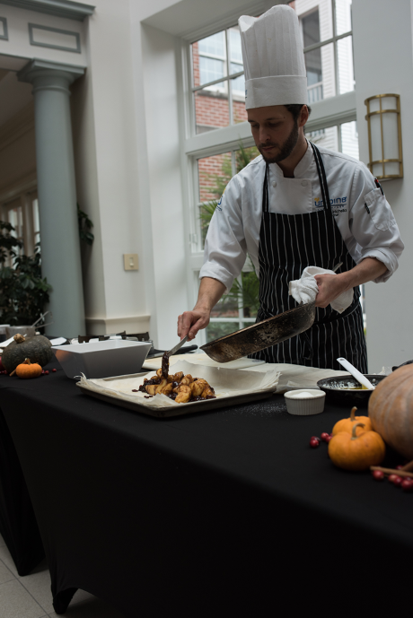 Chef plating a meal in the dining area