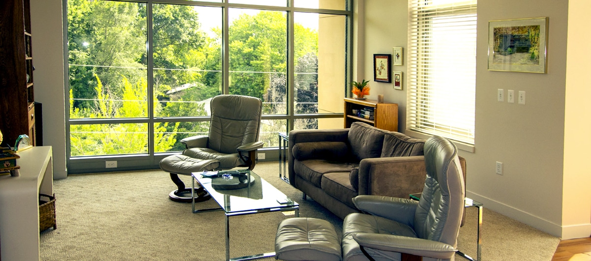 A well-lit common area with modern furniture and large windows