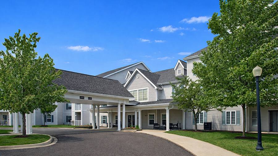 Front entrance of American House Troy with landscaping