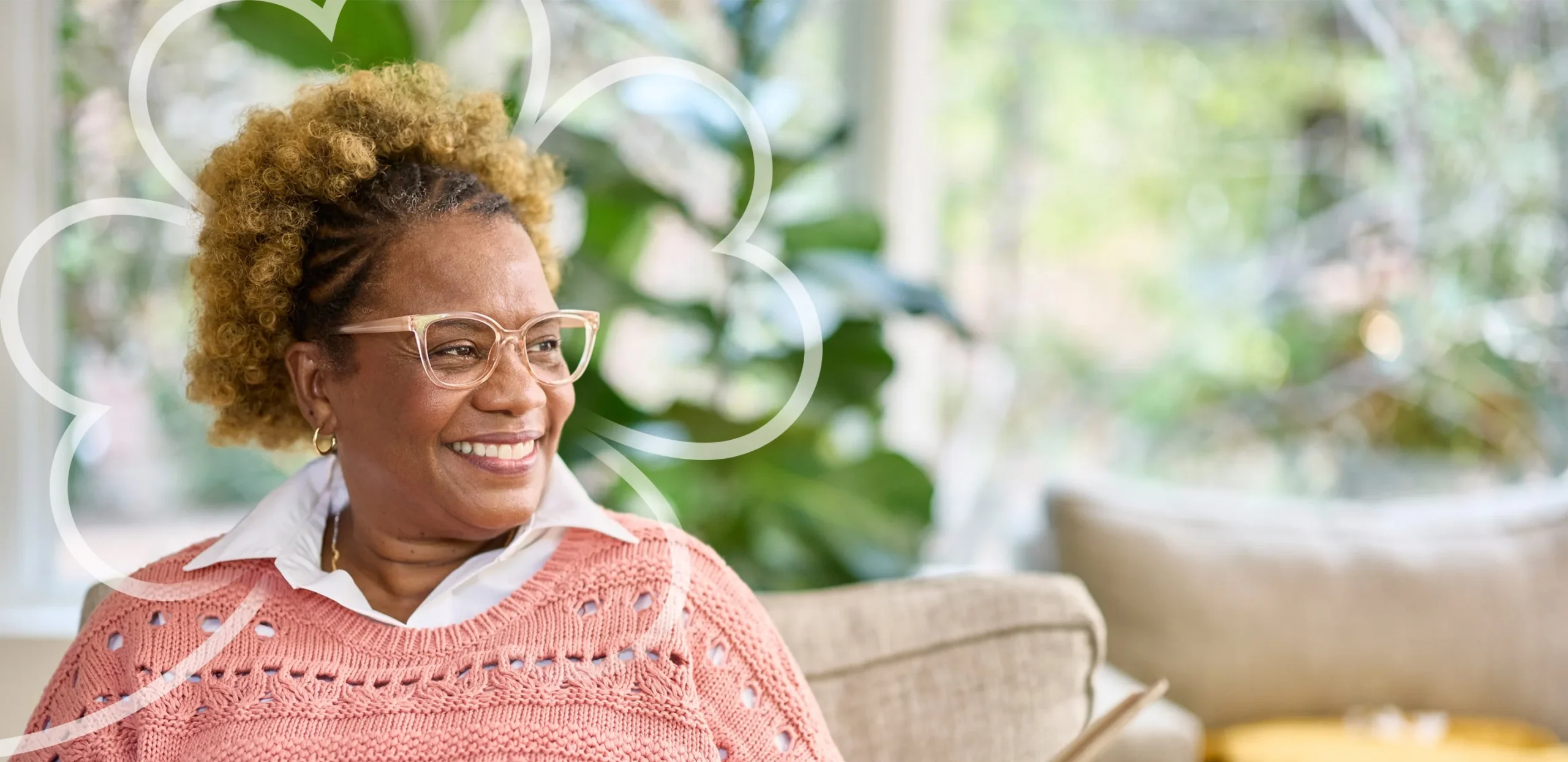 A resident smiling in a bright lounge setting