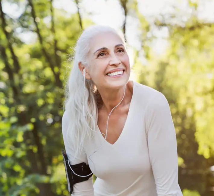 Senior woman enjoying a walk outdoors with a smile