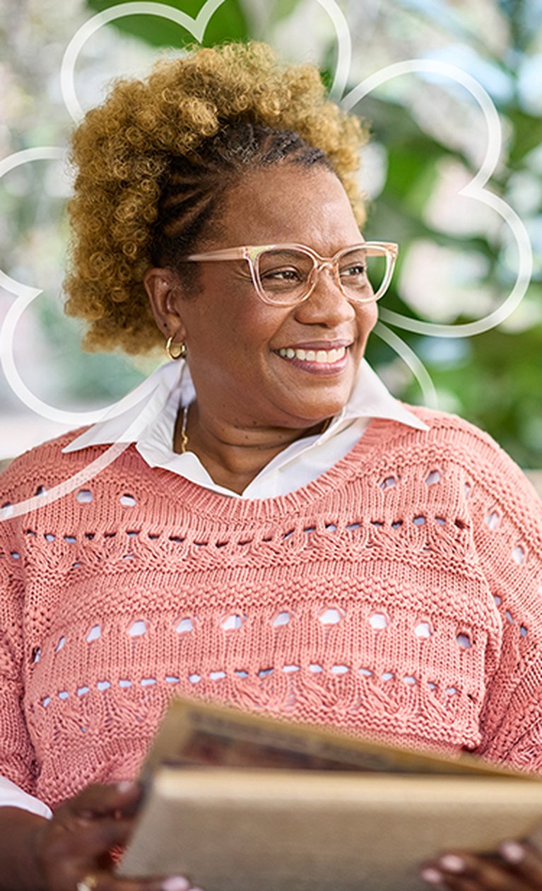 Resident happily reading a book in a cozy setting