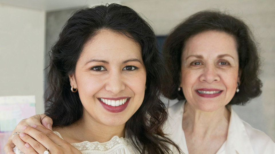 Two smiling women in a bright indoor setting