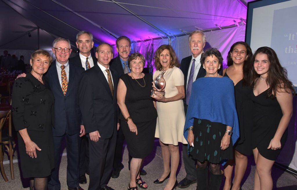 Residents and staff celebrating an award at a ceremony