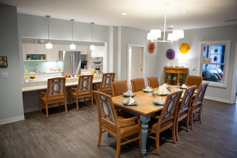 Dining area with large table and chairs in a modern setting