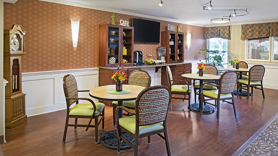 Bright dining area with tables and flowers