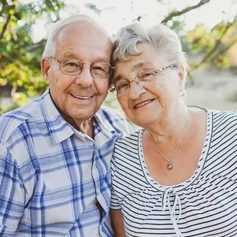 Smiling elderly couple in an outdoor setting