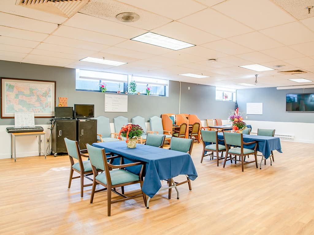 Bright common area with tables and chairs set up