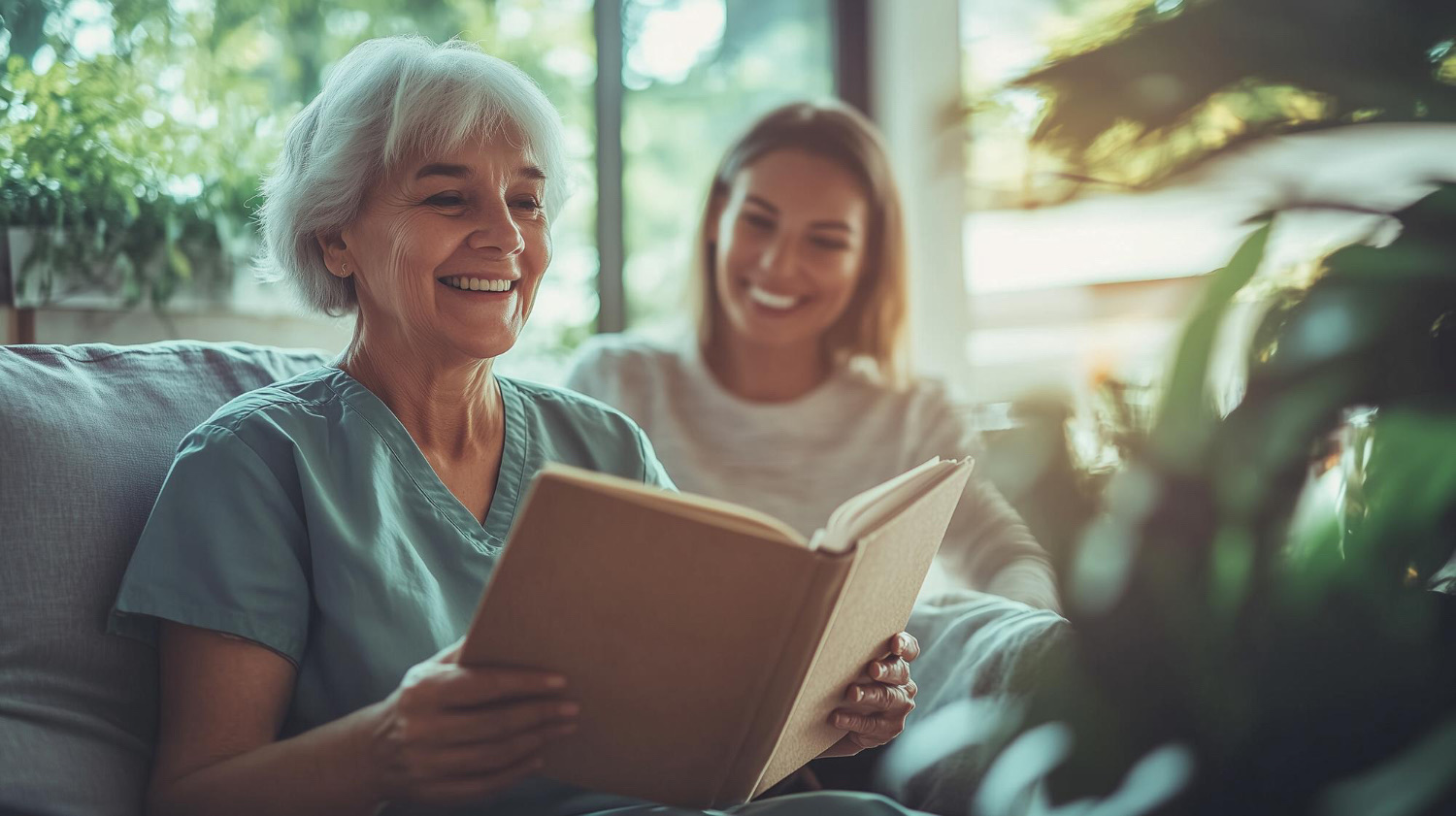 Two women reading and smiling together in a cozy interior