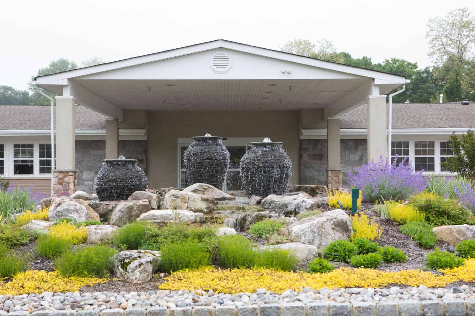 Outdoor fountain with landscaping at the facility entrance