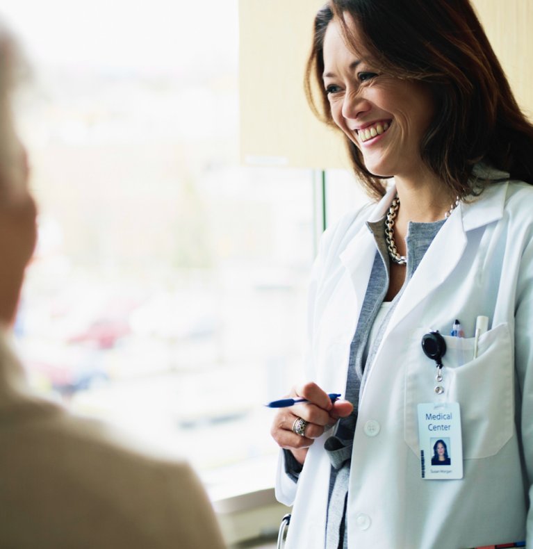 Healthcare professional smiling while interacting with a resident