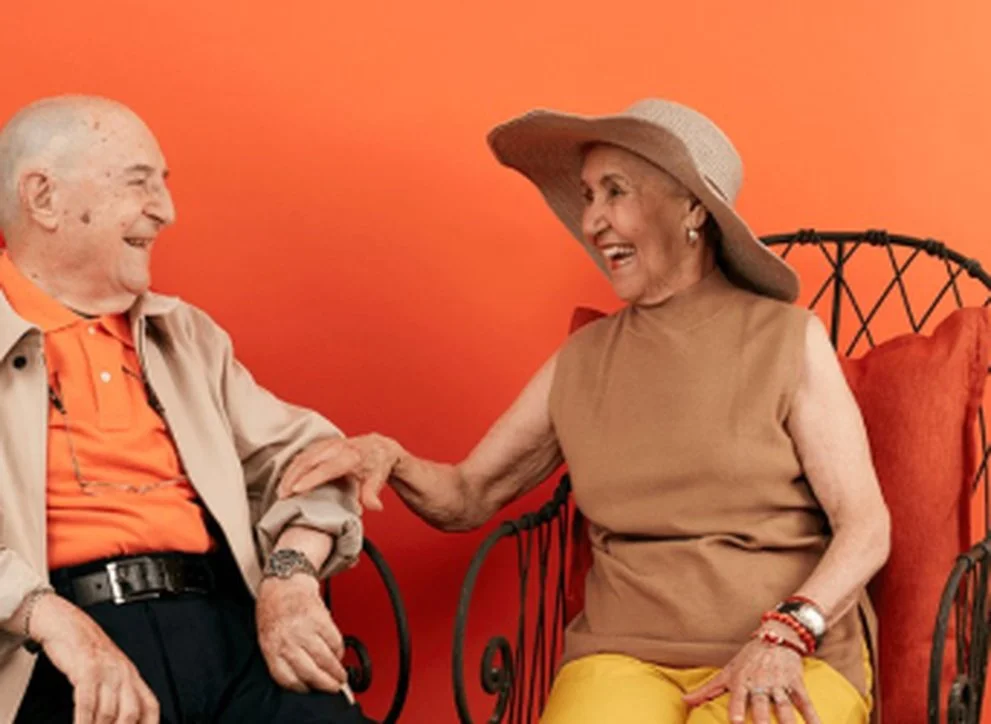 Couple laughing together on a couch