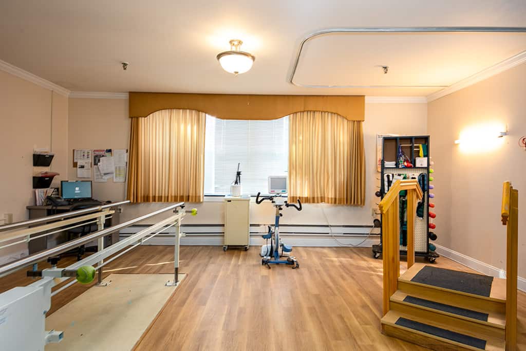 Rehabilitation room with therapy equipment and seating