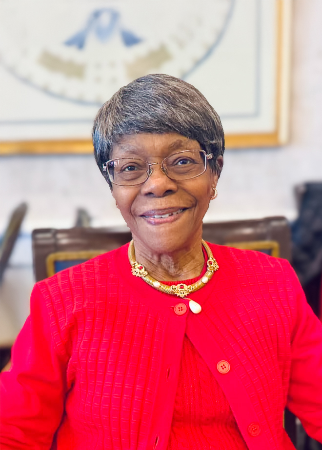 Smiling resident wearing a red sweater in a bright interior
