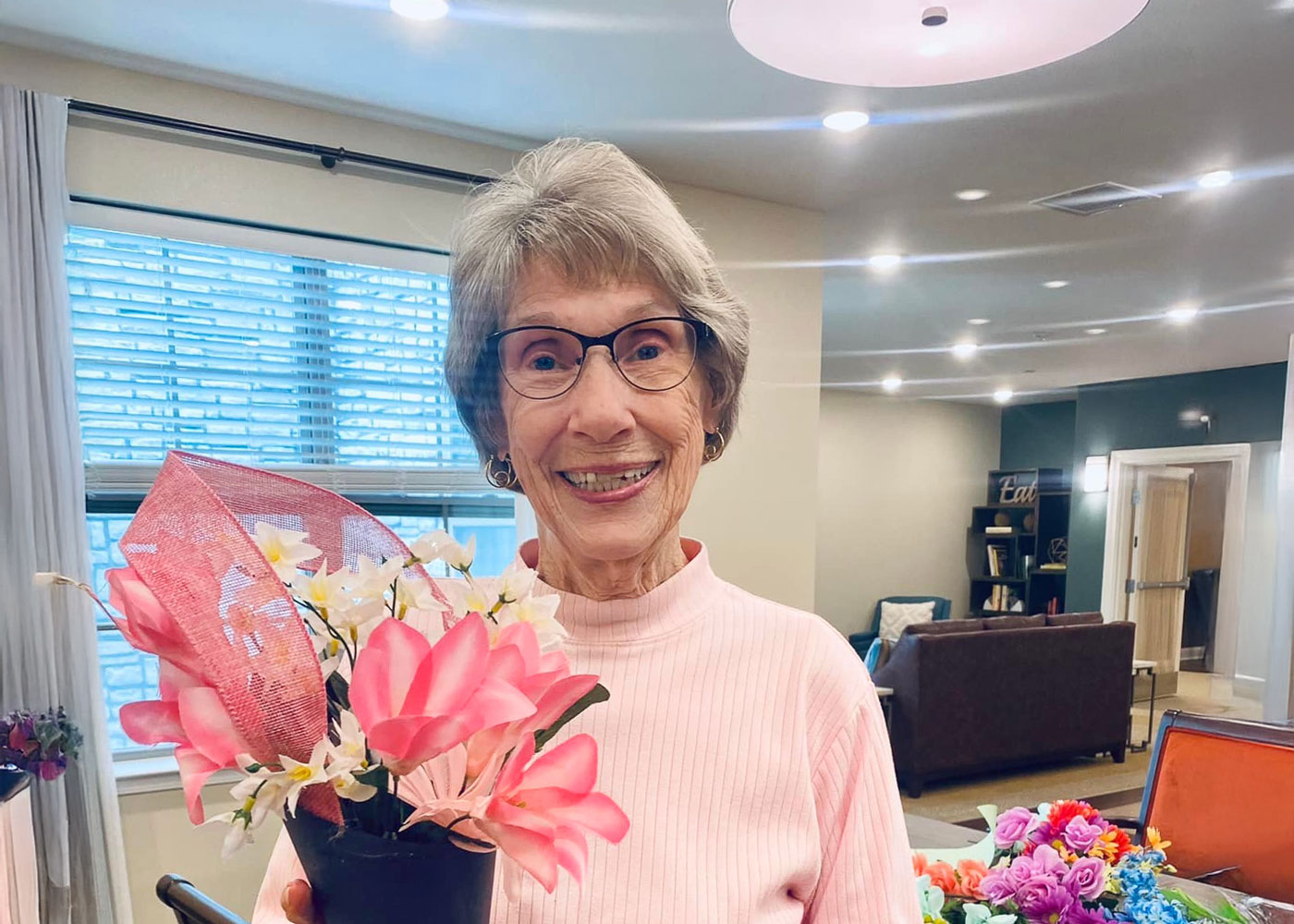 Resident holding a flower pot in a common area