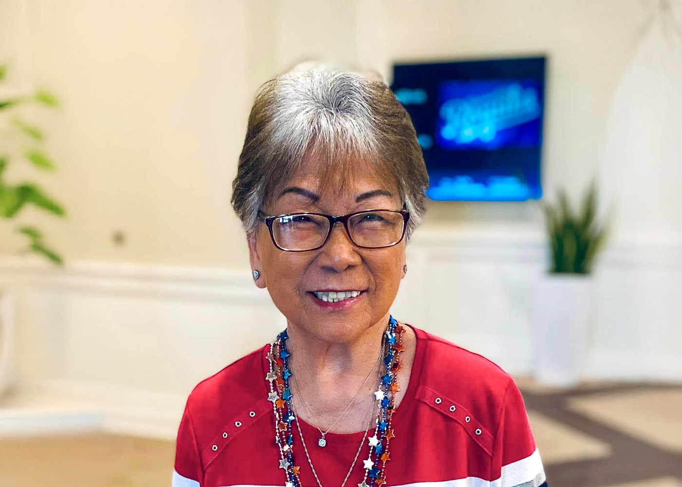 Resident smiling in a common area of the facility