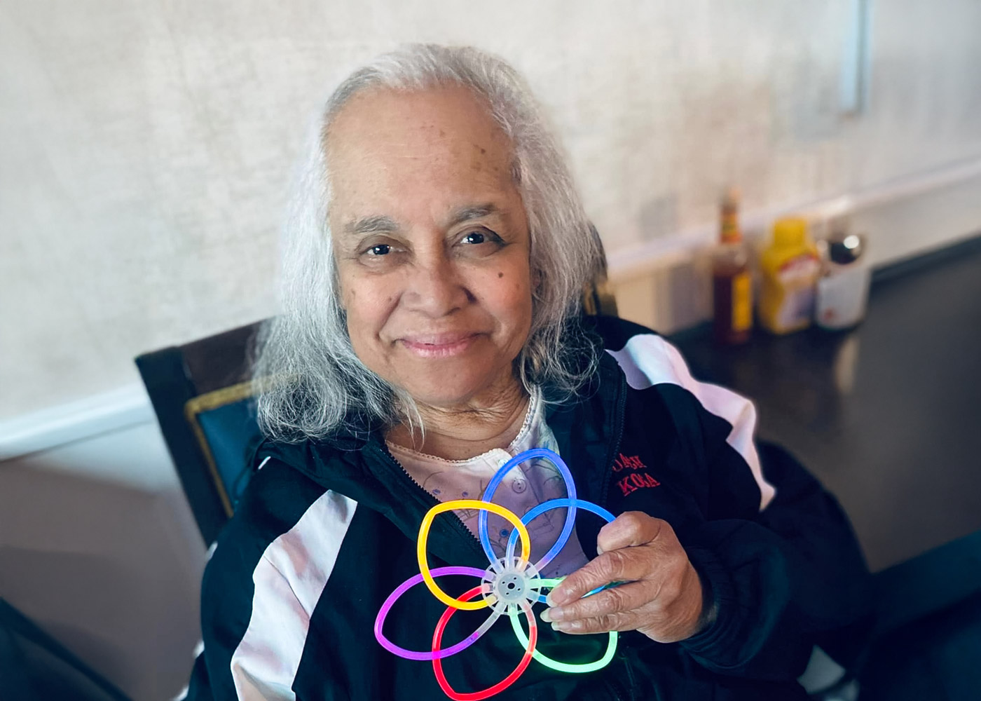Resident enjoying a colorful activity with a smile