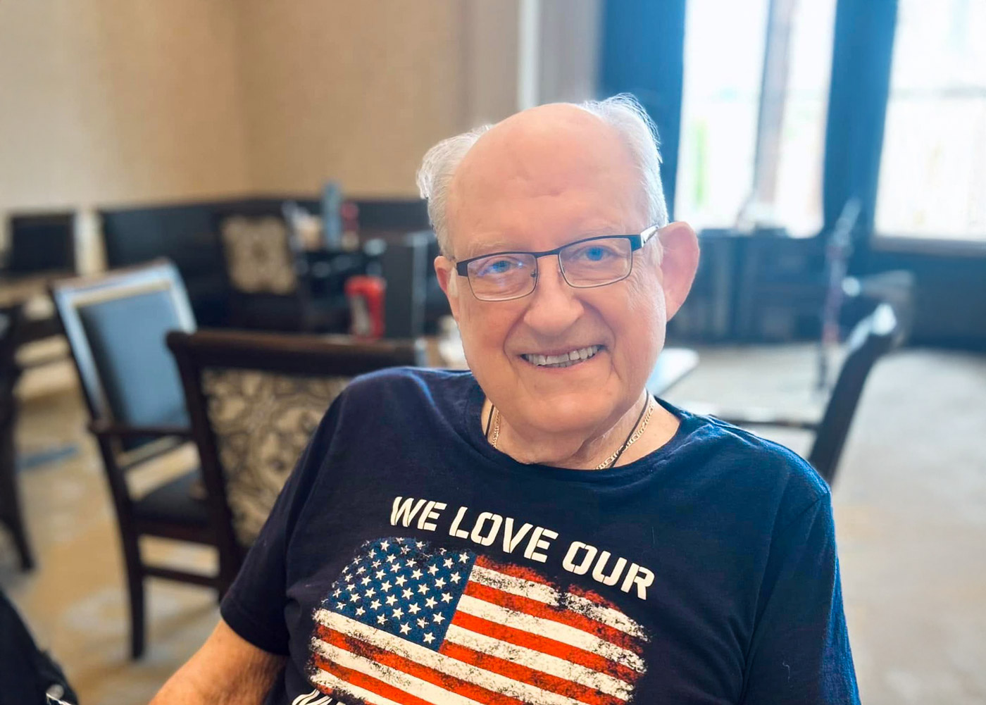 Senior resident smiling in a community space