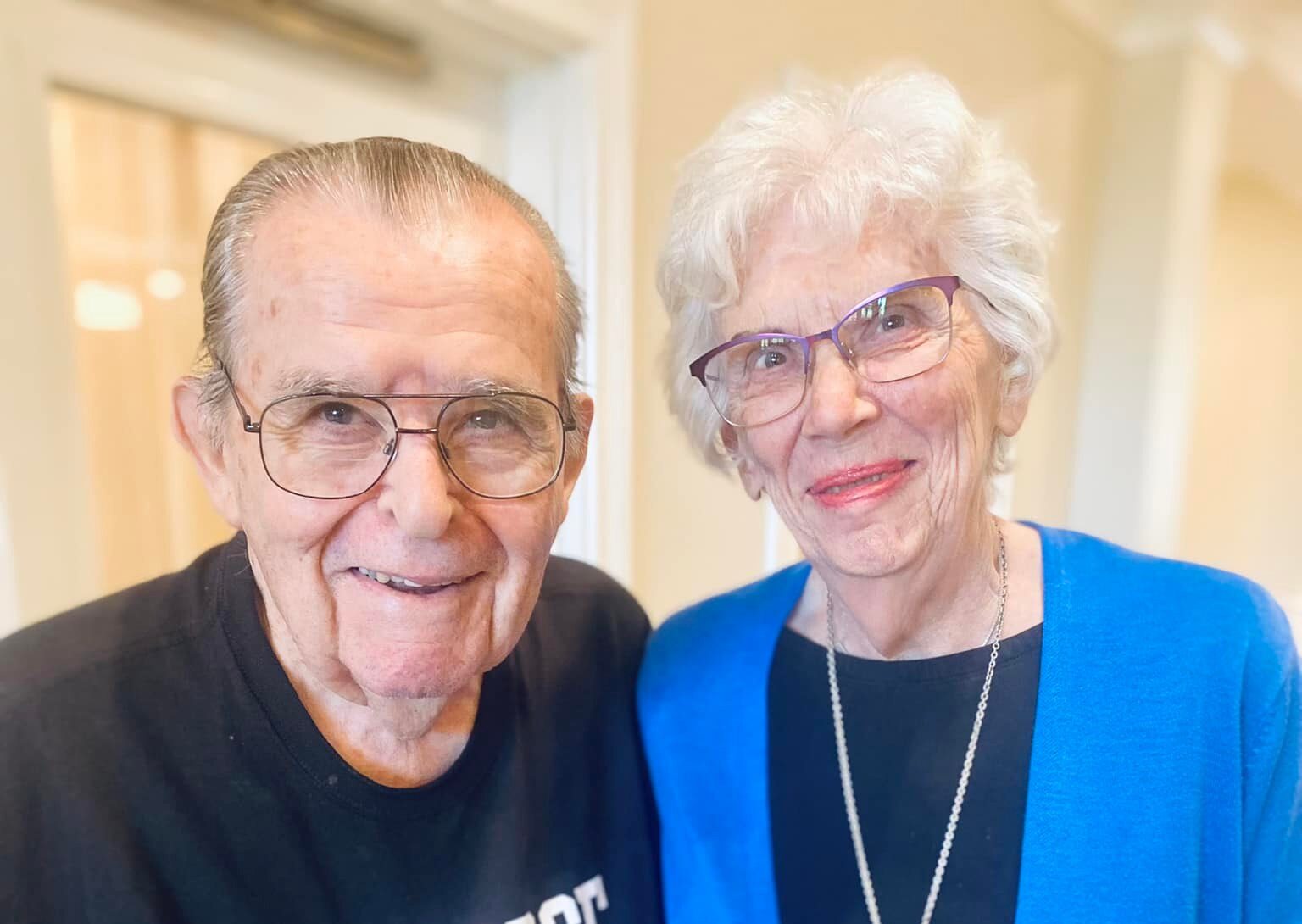 Two residents smiling together in a common area