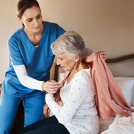A staff member assisting a senior resident