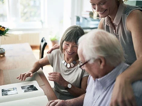 An elderly couple enjoying time with a staff member