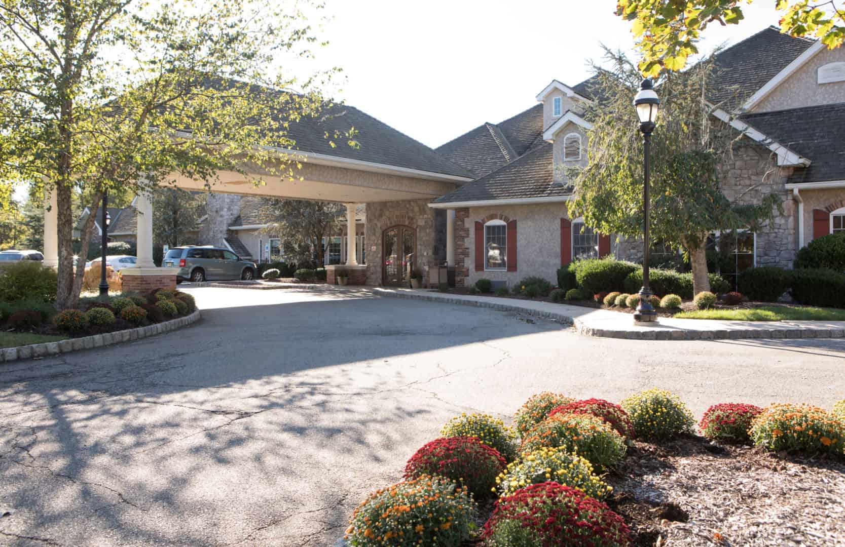 Exterior view of CareOne at Lowell entrance with landscaping