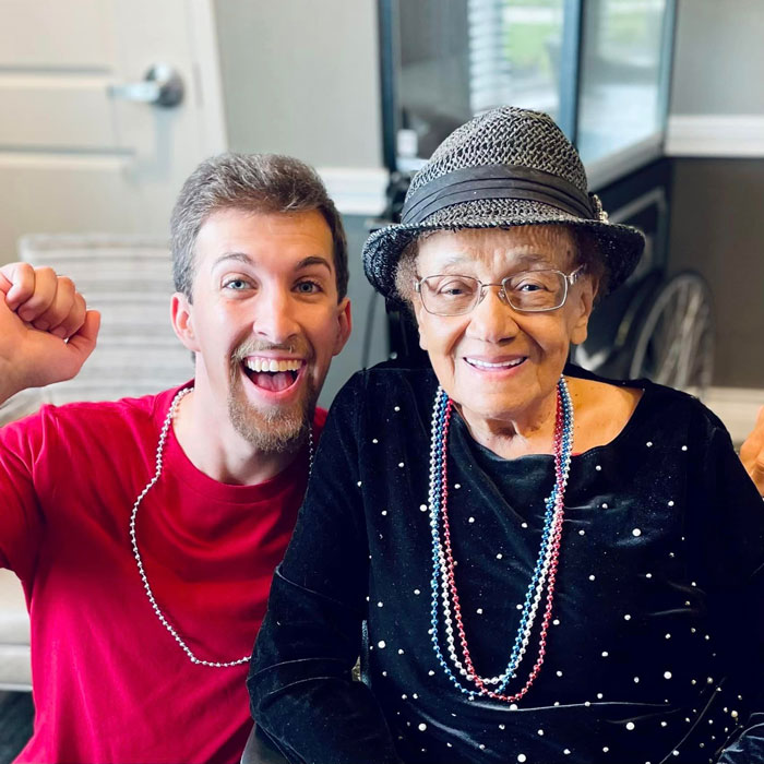 A staff member and resident smiling together