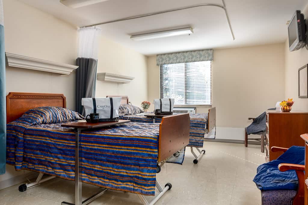 Private resident room with two beds and personal items