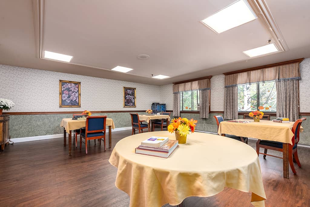 Bright common area with tables and floral decorations