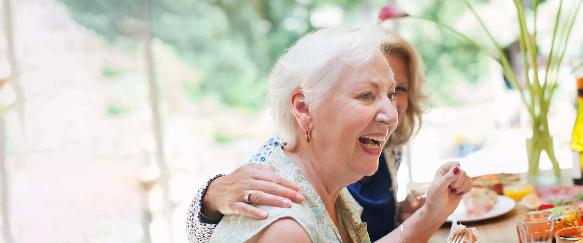 Residents enjoying a meal and laughter together