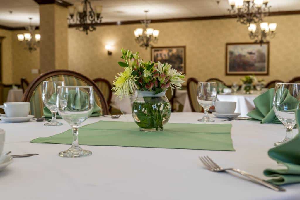 Set dining table with floral centerpiece in a dining room