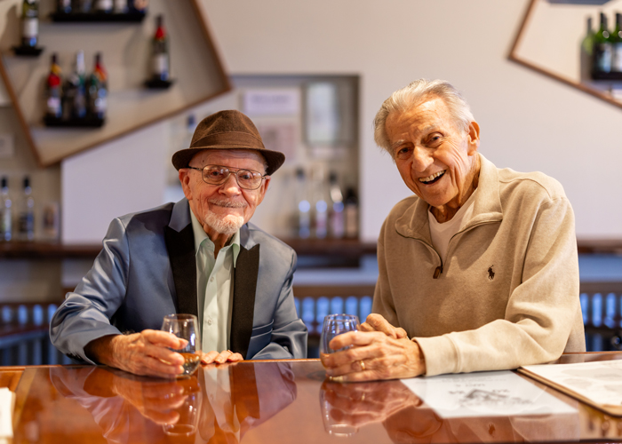 Two residents enjoying drinks at a bar