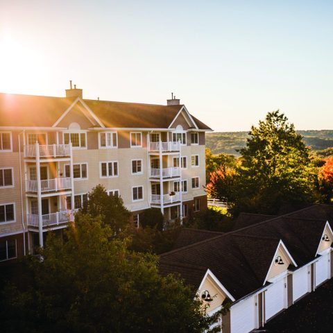 Exterior view of Benchmark Senior Living facility with sunset
