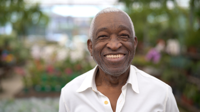 Smiling senior man in a garden setting
