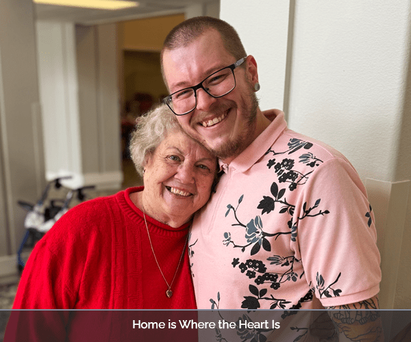 Resident and staff member sharing a joyful moment