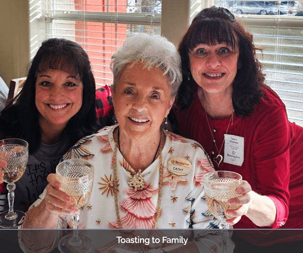 Residents celebrating with glasses raised in a common area