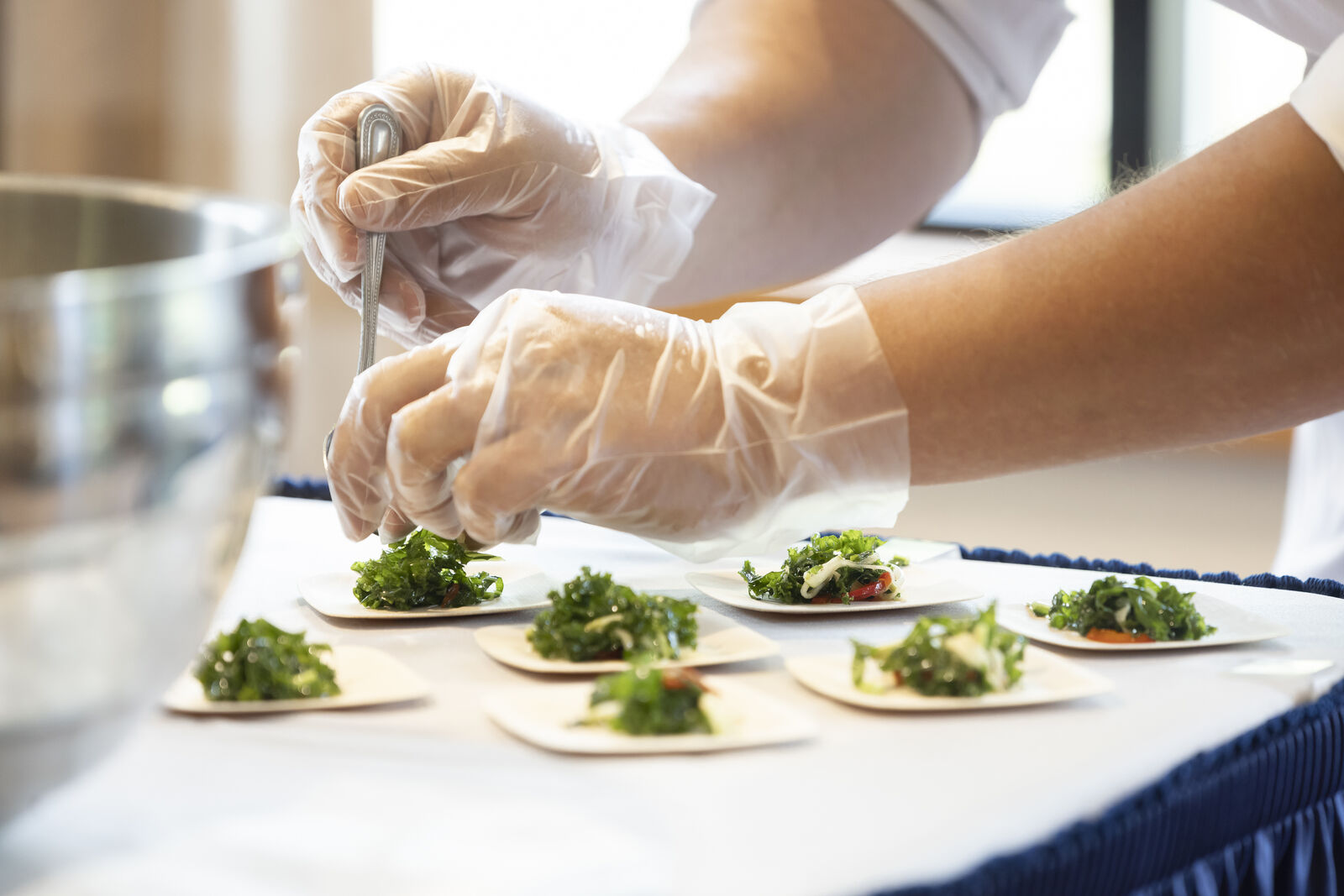 Staff preparing meals with gloves in the kitchen
