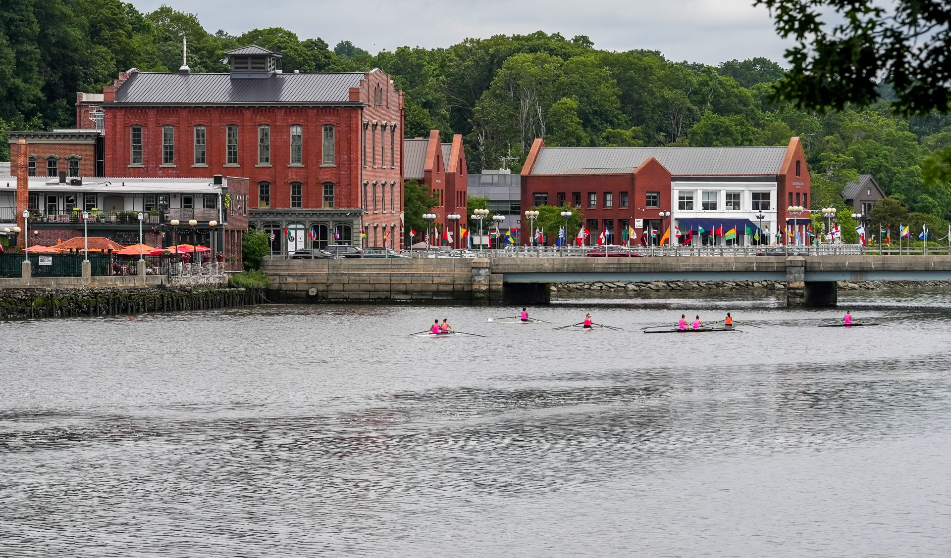 Exterior view of buildings near a waterway with rowers